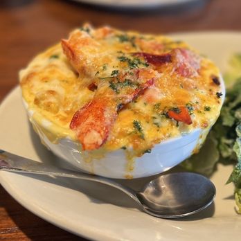 Boston Sail Loft signature dishes Clam Chowder, Fish and Chips, Lobster Mac and Cheese, Stuffed Scallops